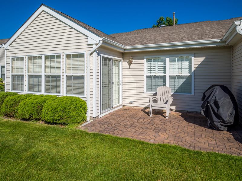 Rear of a home with an attached living space and patio