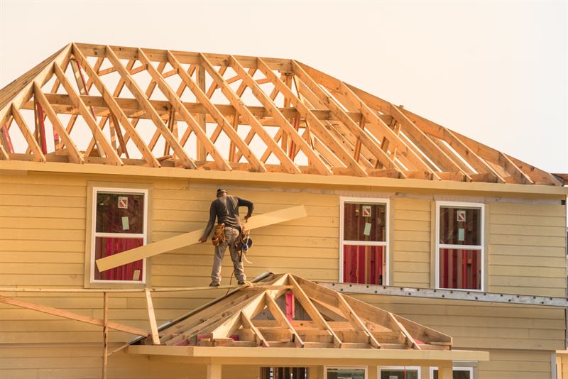 Builder framing the roof of a new home